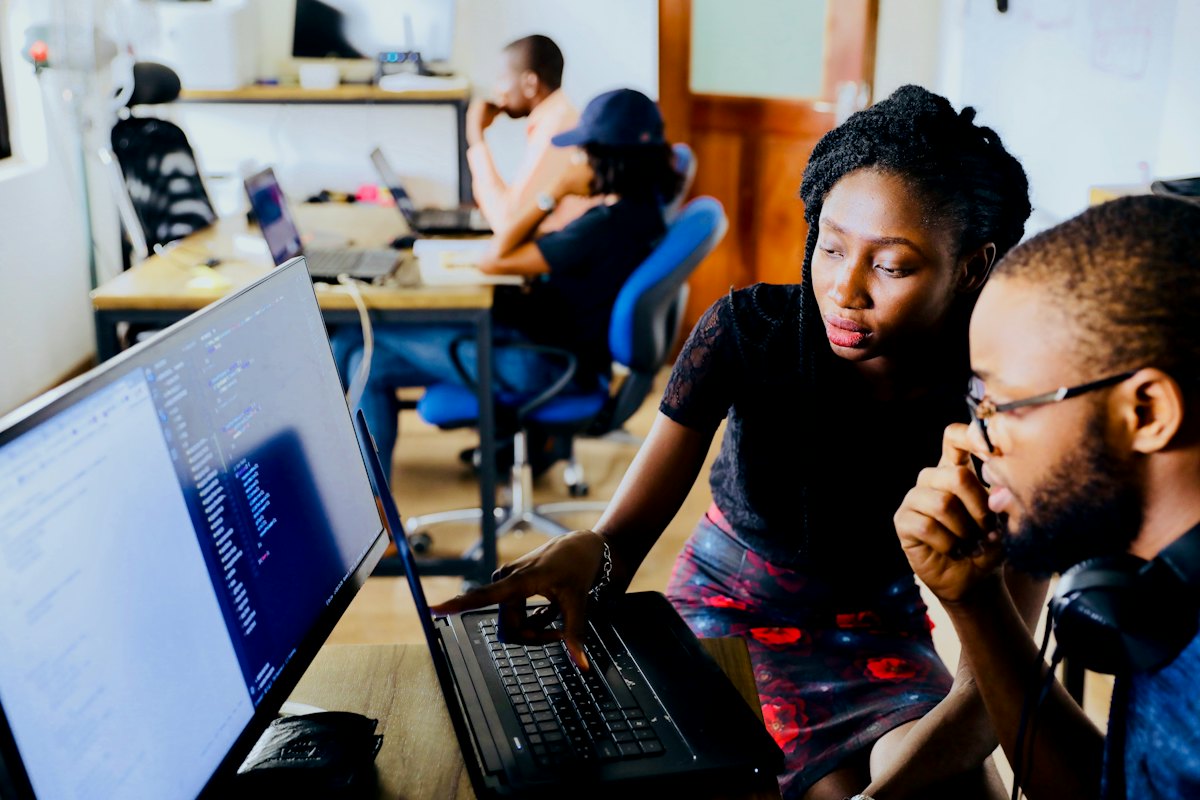 Two engineers reviewing code together at a laptop